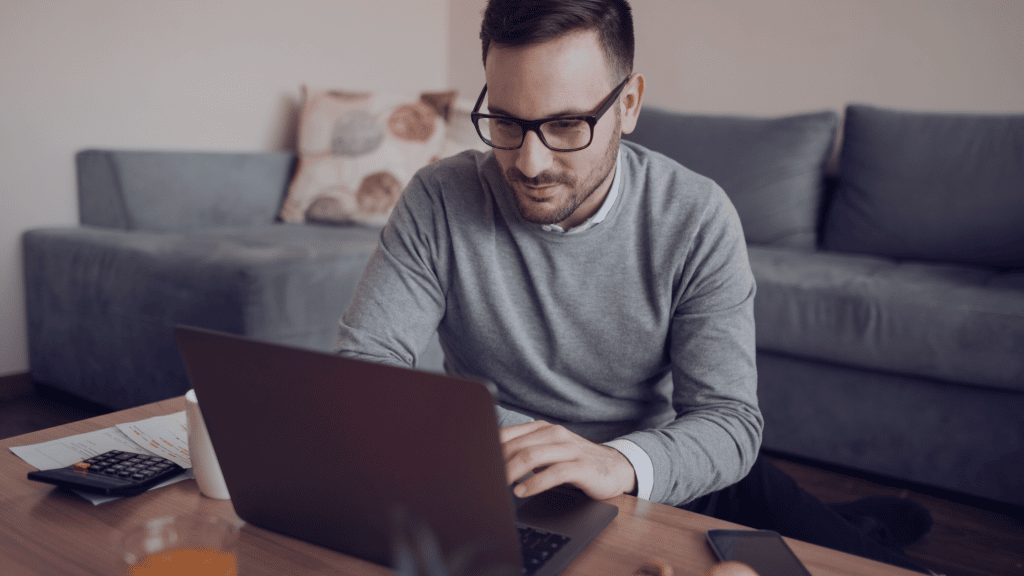 Man on laptop in living room